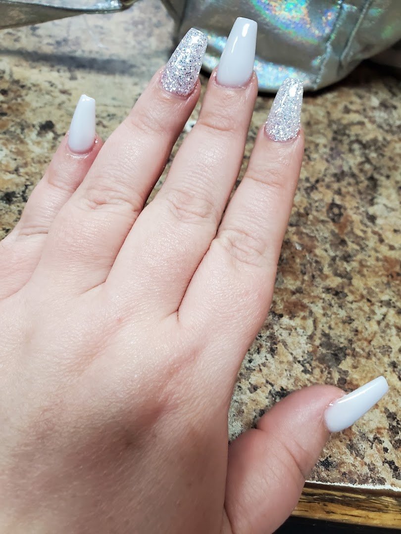 Salon workstation with manicure supplies and finished nails.